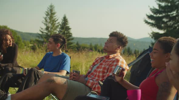 Portrait of Serene Diverse Multiracial Travelers Enjoying Recreation at Campsite in Morning