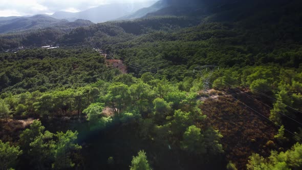 Towers of Power Lines in the Mountain Forest Filmed By Drone at Summer Day in Turkey