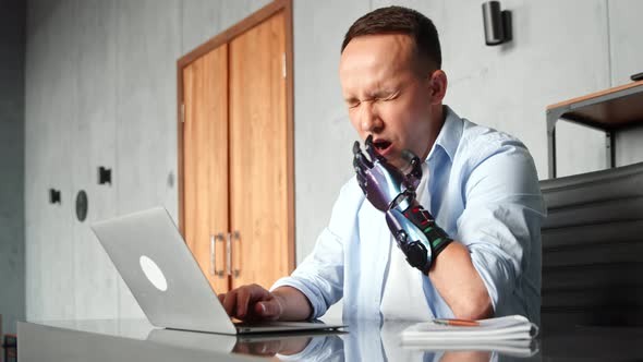 Disabled programmer with bio hand high tech prothesis solves problem typing on laptop