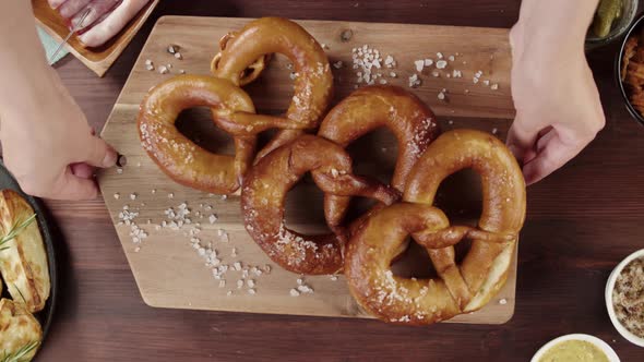 Putting Fresh Pretzels on Table Top View