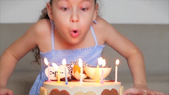 Happy Cute Little Girl or Lovely Daughter Sitting on the Couch at Home of 8 Years Old Celebrates Her