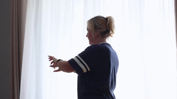 Senior Woman Doing Arthritis Hands Recovery Exercise at Home