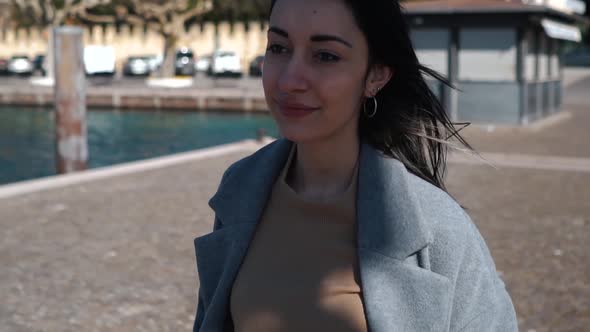 Slow motion shot of woman with nose piercing walking at harbour