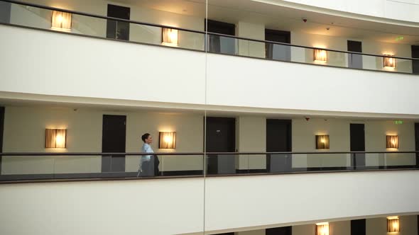 Adult Woman Walking Inside Space of Luxury Hotel