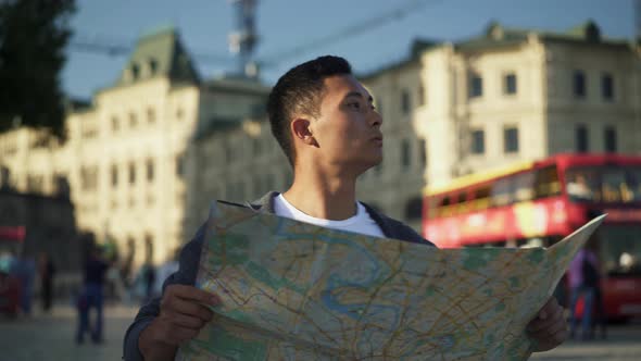 Real Time Shot of a Young Asian Man Looking at a Map. Tourist in Moscow. Moscow Is the Capital of