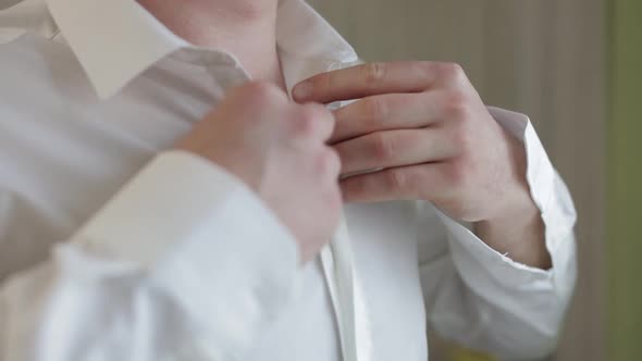 Groom Fixes His White Shirt. Wedding Morning. Businessman. Slow Motion. Close-up Shot. Portrait