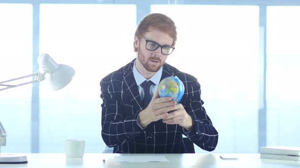 Businessman Holding and Reading World Globe, Countries