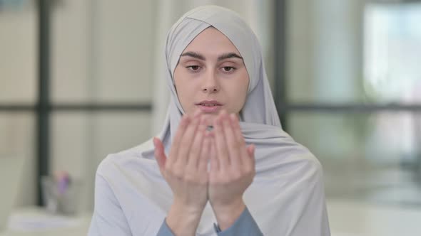 Young Arab Woman Praying with Eyes Closed
