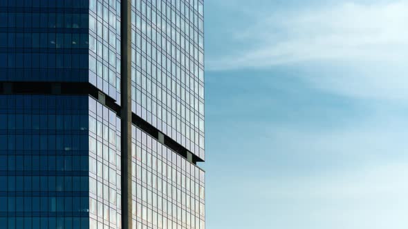 Timelapse Glass Skyscraper High Office Building Facade Blue Sky and Clouds Moving Fast Reflected on