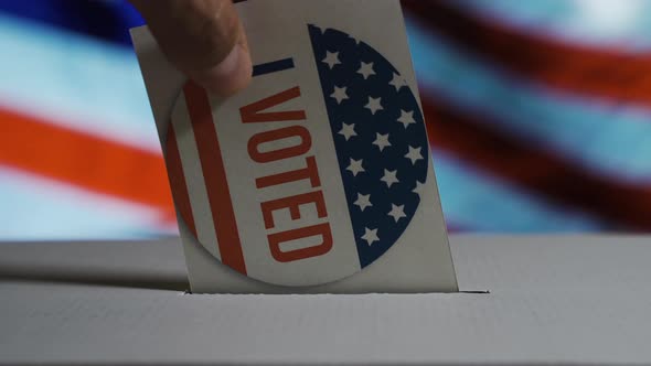 USA Elections 2020, the Hand of a Man Putting His Vote in a Ballot Box Withthe USA National Flag on