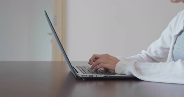 Woman type on laptop computer at home