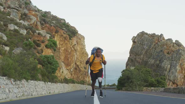 Sporty mixed race man with prosthetic leg hiking