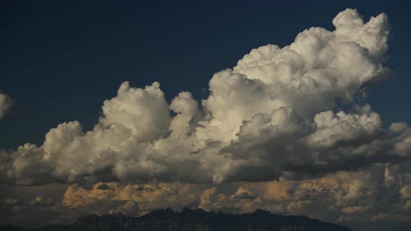 Time lapse of voluminous white clouds over blue sky alt
