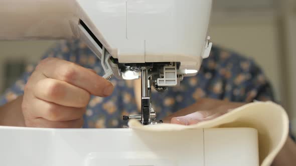 Hands working with a sewing machine