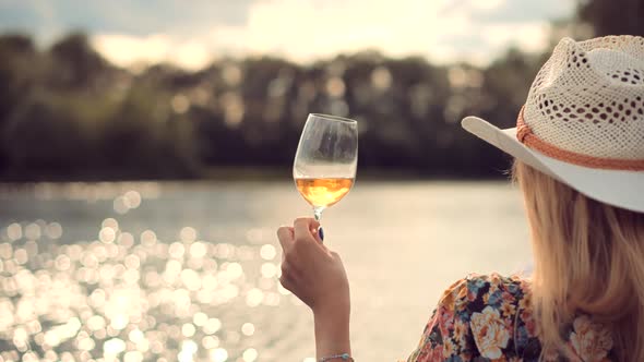 Girl Drinking Wine On Sunset.Woman Drinking White Wine.Woman Hold Glasses And Drinking Wine