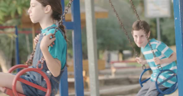 Children swinging together at a public playground