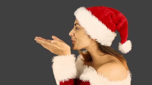 Sexy santa girl blowing over hands