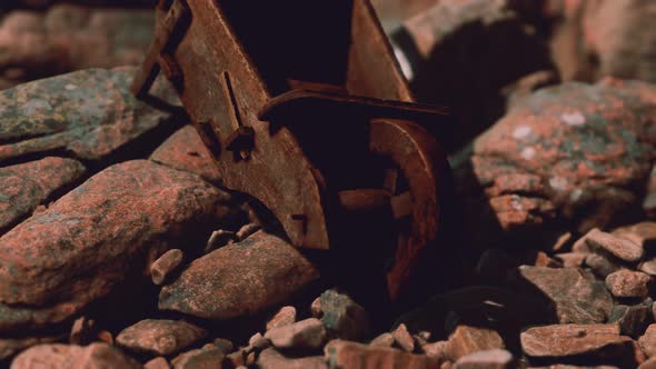 Abandoned Wooden Mine Wheelbarrow on Rocks alt
