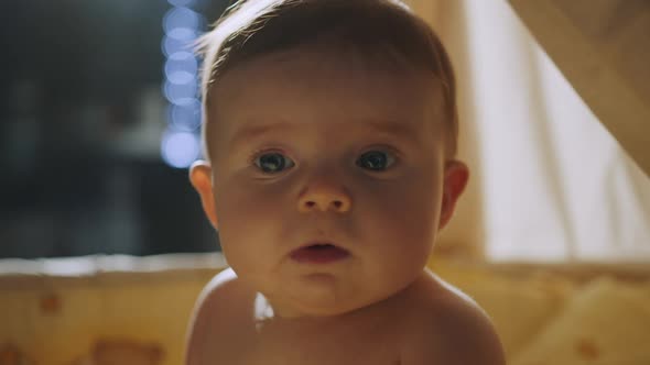 Baby Standing in White Wooden Crib in the Evening Face of Happy Baby Boy in