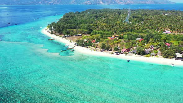 Luxury drone island view of a white sandy paradise beach and blue sea background in vibrant 4K