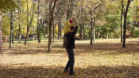 Happy Funny Family Daddy Children Kids Have Fun in Park with Dad Enjoying Autumn Fall Nature Weather