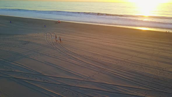 Aerial drone uav view surfers at the beach and ocean.