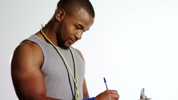 Portrait of trainer writing on clipboard