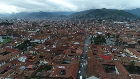 slow camera movement with drone of Cusco city, general shot in a cloudy and foggy day, country Peru