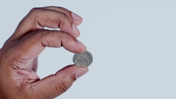 Hand Holding 20 Pence Coin