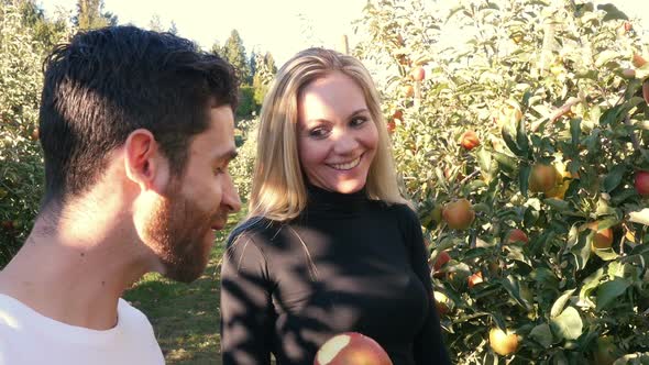 Man eating apple in apple orchard