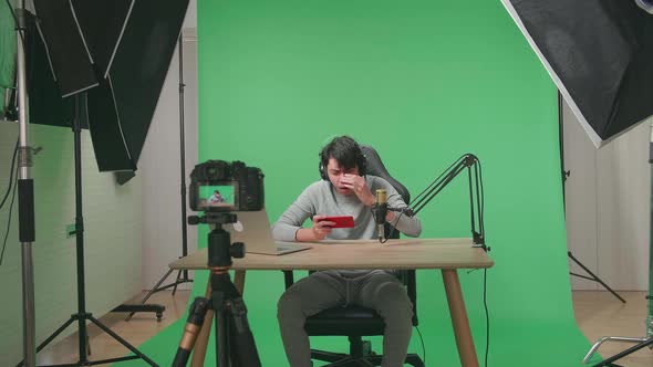 Camera Recording Asian Man Gamer Losing Mobile Phone Game On The Green Screen With Light Equipment