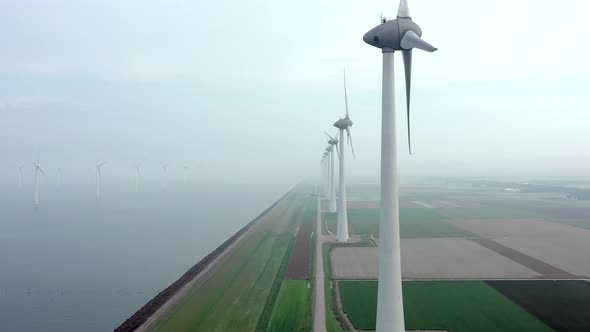 Aerial View of a Giant Wind Farm Used for Renewable Energy on a Foggy Day