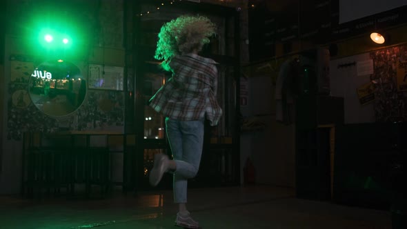 Carefree Crazy Girl Dancing on the Dance Floor in a Nightclub