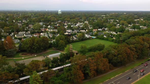 A high angle view over a highway in the evening. It is a cloudy day as the drone pan right and dolly