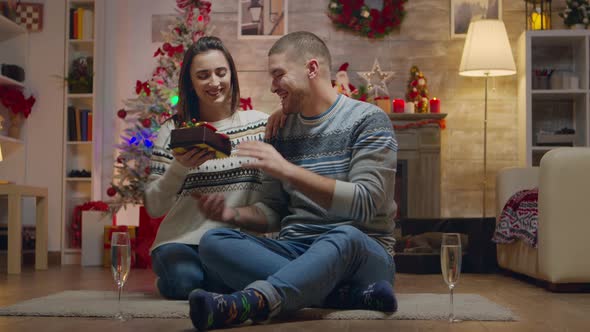 Young Woman Surprising Her Husband with a Gift