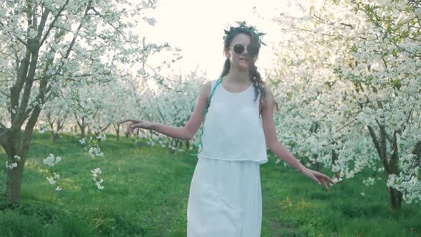 girl walking on a blooming garden and resting