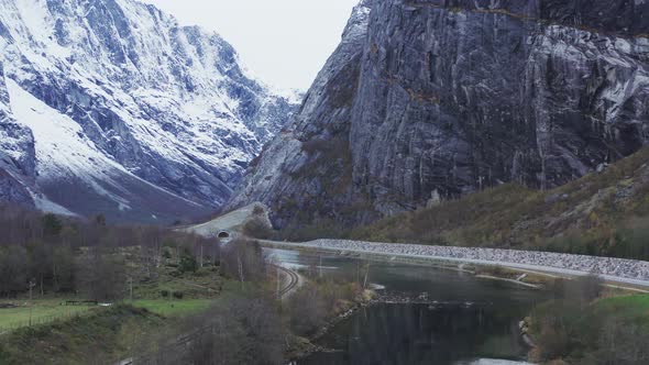 Narrow Road By The Scenic Mountain Of Trollveggen In Romsdal Norway - aerial shot