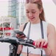 Slow motion young woman using smartphone scaning qr code unlocking kick scooter - VideoHive Item for Sale