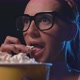 Woman watching movies and eating popcorn at the cinema, video montage - VideoHive Item for Sale