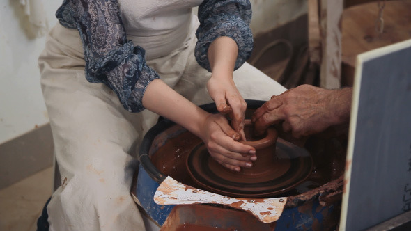 Potter Working With Clay On The Machine