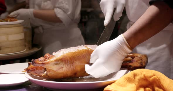 Chef cutting of grilled duck in restaurant