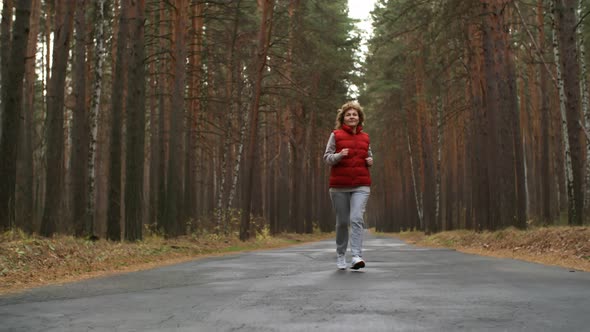 Aged Active Woman Jogging Outdoors