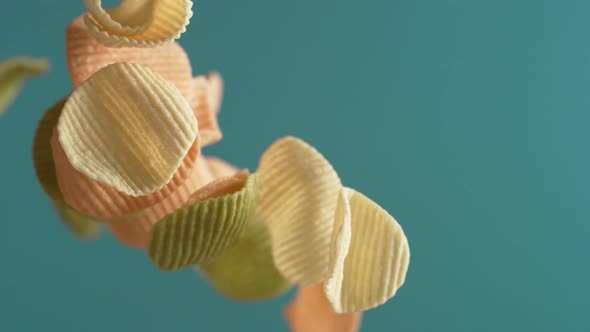 Camera follows potato chips flying in the air. Slow Motion. alt