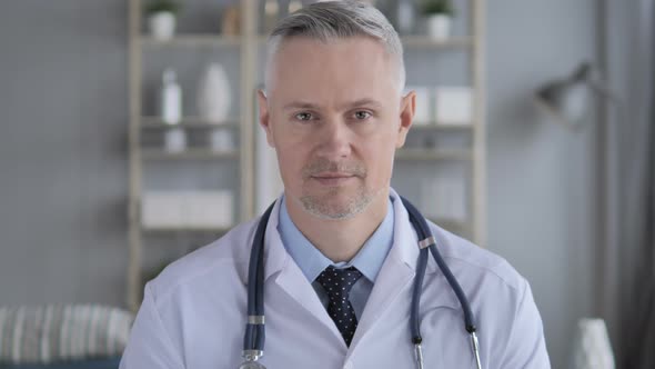 Portrait of Serious Doctor with Grey Hairs