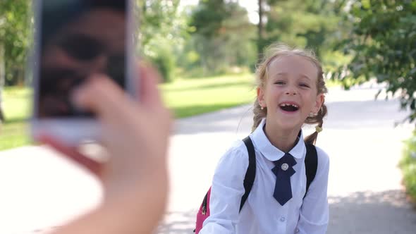 Mother Taking Photos of Daughter Before School