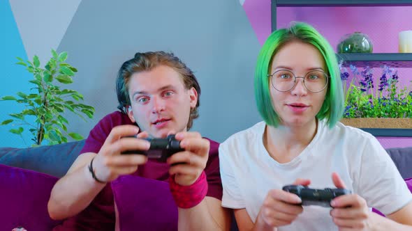 A Couple in Pajamas Playing a Game Console