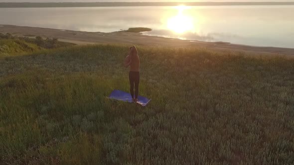 Young Sportive Man Practicing Yoga at Sunset