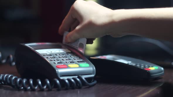 Woman Pays By Credit Card Using Terminal