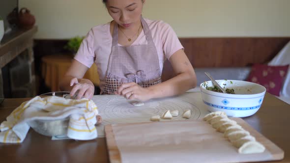 Housewife kneading dough in kitchen