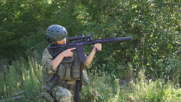 Strong Brave Female Army Soldier with Rifle Machine Gun Standing in Forest